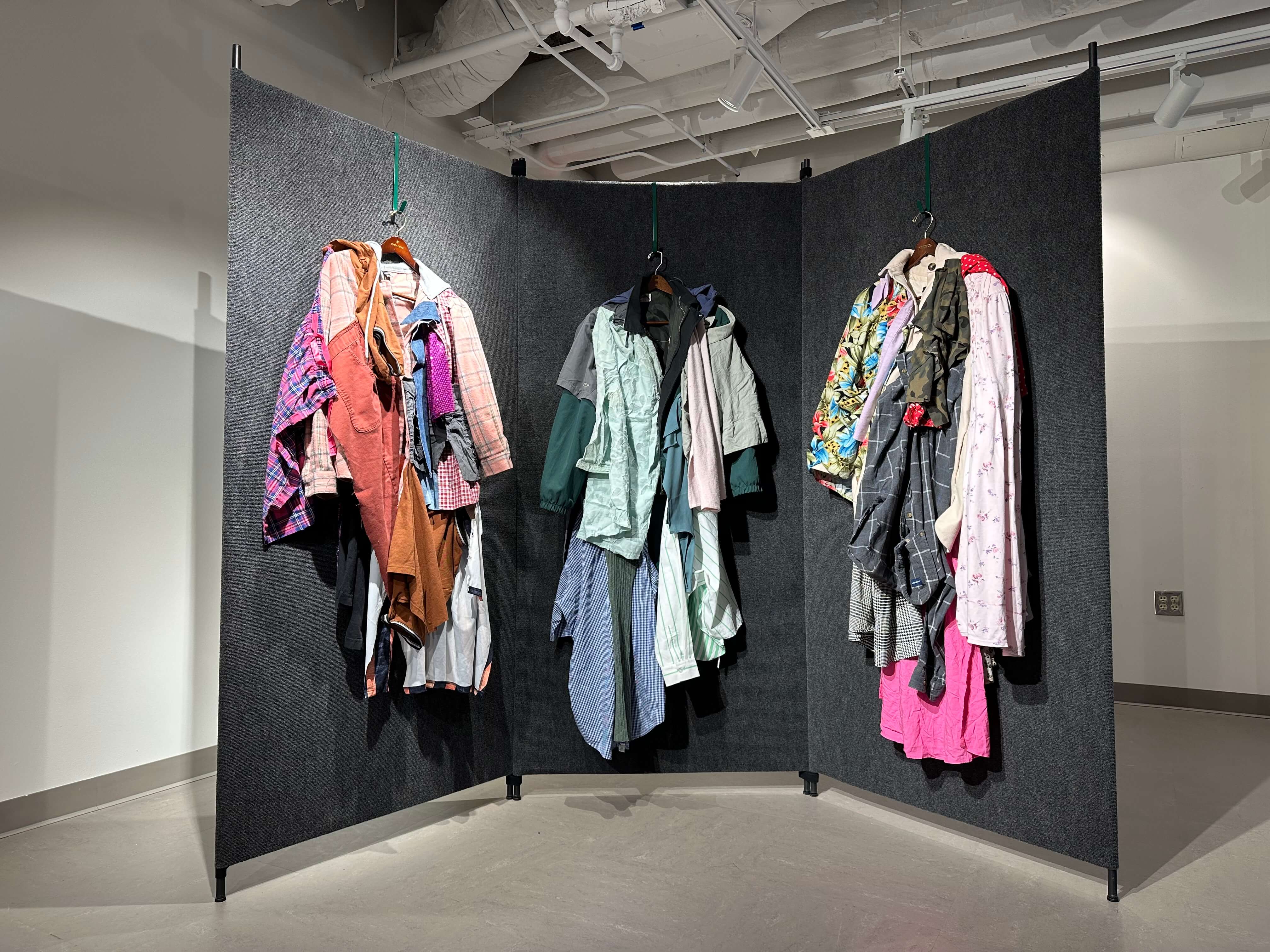 Three colorful coats made from scraps of trash-bound clothes