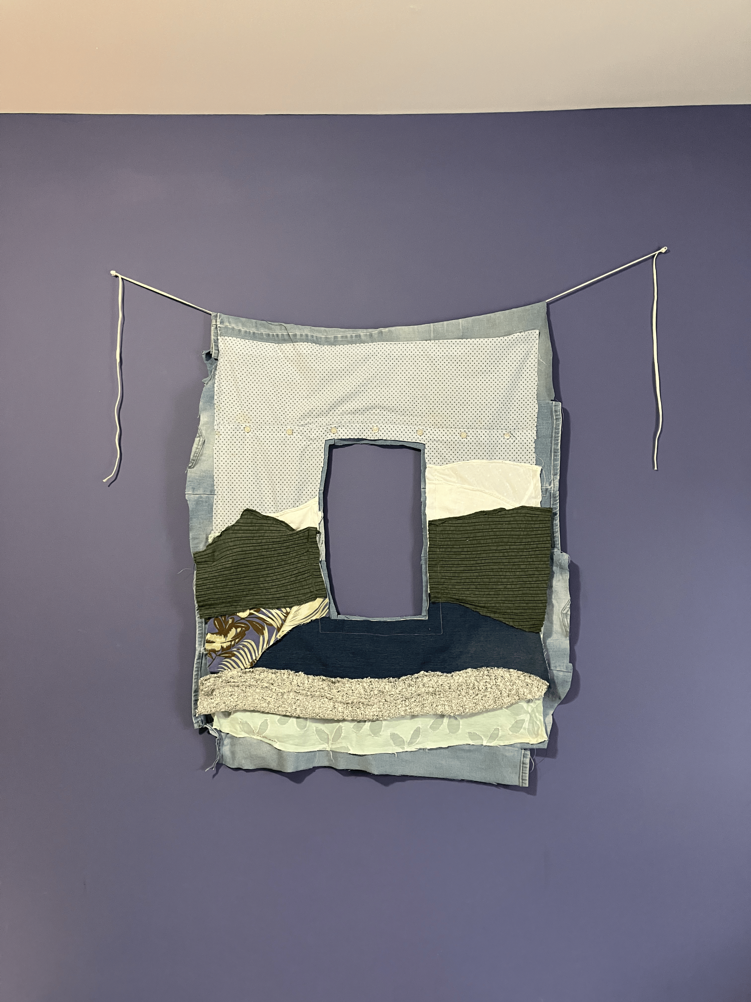 A tapestry of an abstract landscape with a rectangular hole cut out of the middle